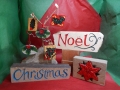 hand carved and painted Christmas is £95, £6 for the hanging decorations . The Poinsettia carving is £75 and the Noel with a scroll is £58