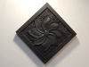 Swirling flower carved in Welsh slate and oiled. 5.5 inches square. £65