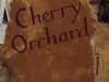 House name, Forest of Dean red sandstone, painted plum        