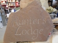 Hand carved unpainted house sign
