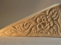 triangle carved with a rose and leaves.