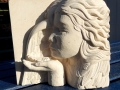Angel, blowing a leaf. Hand carved Lepine limestone.