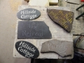 A selection of unfinished lettering commissions in various Forest of dean sandstone and slates.